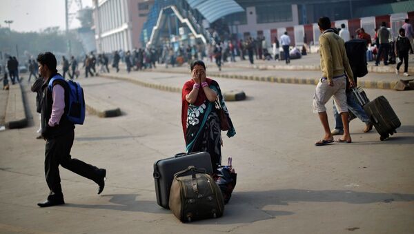 Женщина ждет общественного транспорта во время общенациональной забастовки в Индии