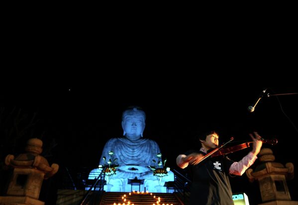 Статуя Будды освещена синим светом в рамках акции Light it Up Blue в Кобе, Япония