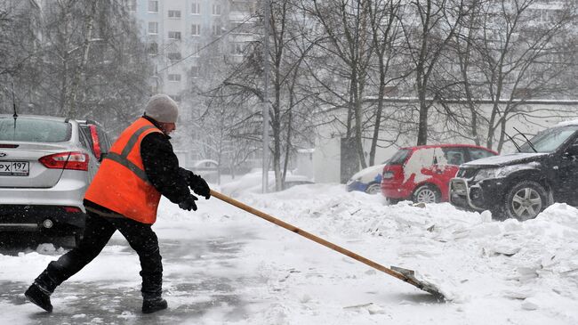 Дворник убирает снег