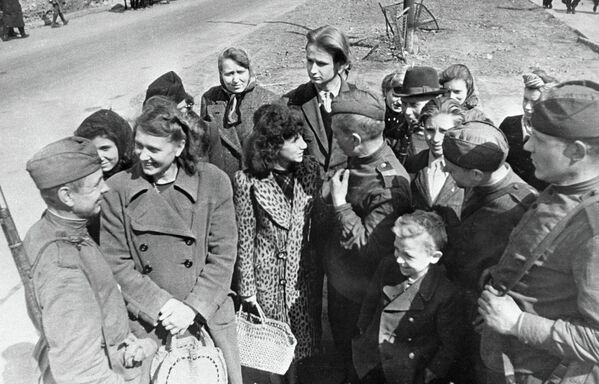 Советские бойцы беседуют с жителями Берлина
