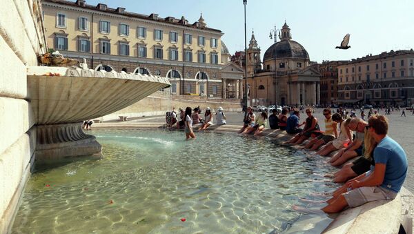 Люди сидят в фонтане в жаркий летний день в Риме