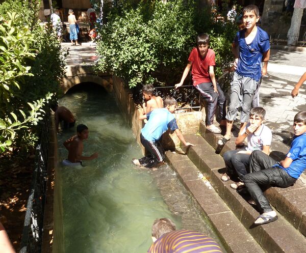Дети купаются в фонтане в турецком городе Урфа (Шанлыурфа)