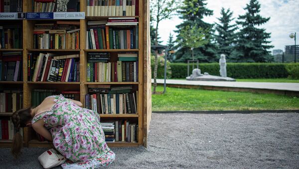 Девушка у книжного павильона в Парке искусств Музеон
