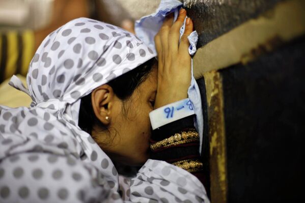Мусульманские паломники прикасаются к Каабе в Большой мечети Мекки