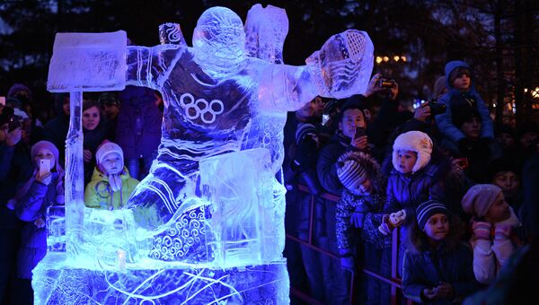 Зрители около ледовой скульптуры во время эстафеты Олимпийского огня.