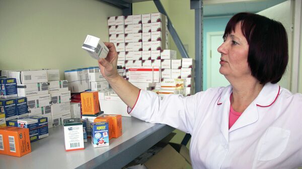 Сотрудница томского центра Анти-СПИД разбирает лекарства для ВИЧ-положительных людей. Архивное фото