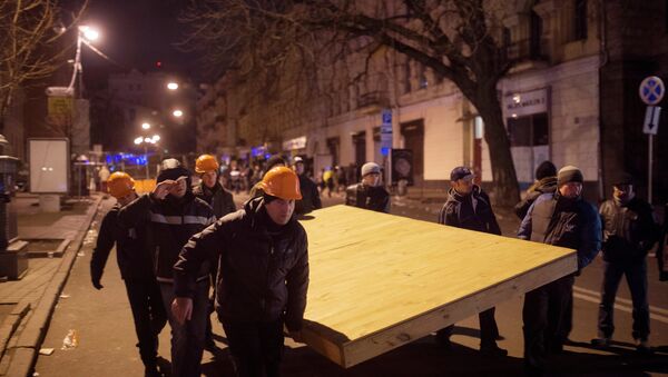 Рабочие, поддерживающие сторонников евроинтеграции, помогают строить баррикады в центре Киева. Фото с места событий