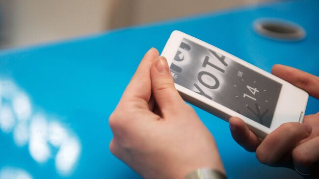 Посетитель московского торгового центра Атриум рассматривает новый смартфон YotaPhone, архивное фото Посетитель московского торгового центра Атриум рассматривает новый смартфон YotaPhone, архивное фото