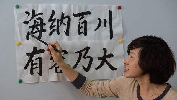 Преподаватель-волонтер Института Конфуция из Китая дает мастер-класс участникам конкурса каллиграфии в ДВФУ в Приморье