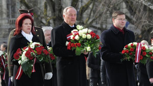 Президент Латвии Андрис Берзиньш (в центре) на церемонии возложения цветов к памятнику Свободы