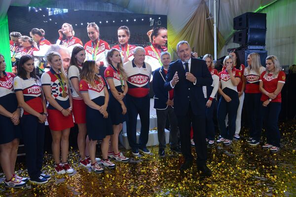 Дмитрий Рогозин (на первом плане) приветствует женскую сборную России по гандболу во главе с главным тренером команды Евгением Трефиловым (в центре).