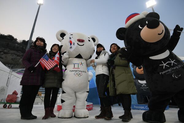Зрители фотографируются с талисманами зимних Олимпийских игр и Зимних Паралимпийских игр-2018 в Пхенчхане