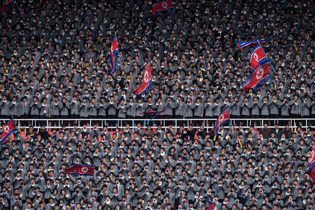 Болельщики сборной Северной Кореи на стадионе имени 1 мая в Пхеньяне