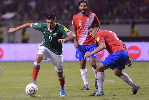 Нападающий сборной Мексики Рауль Хименес (слева) и защитник сборной Коста Рики Джонни Акоста (справа)