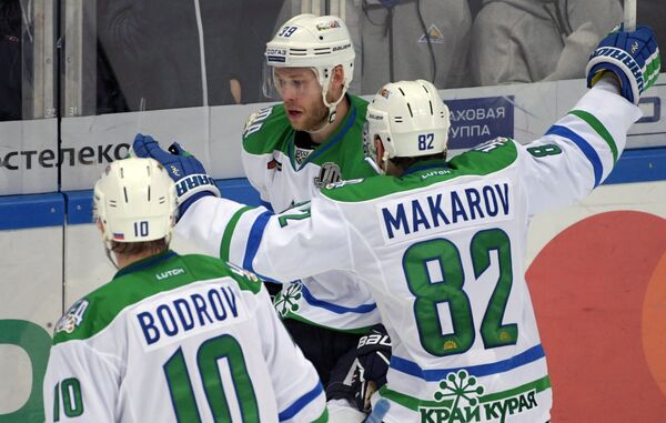 Хоккеисты Салавата Юлаева Евгений Бодров (слева), Игорь Макаров (справа) и Денис Кокарев радуются заброшенной шайбе