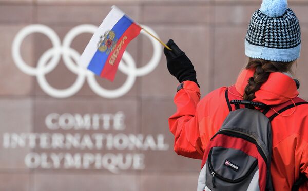 Российский флаг на фоне логотипа Международного олимпийского комитета (МОК)