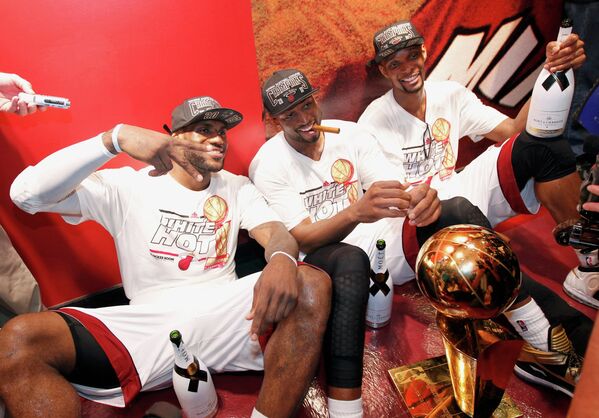 Баскетболисты Майами Лебро Джеймс, Дуэйн Уэйд и Крис Бош (слева направо) празднуют победу в плей-офф НБА