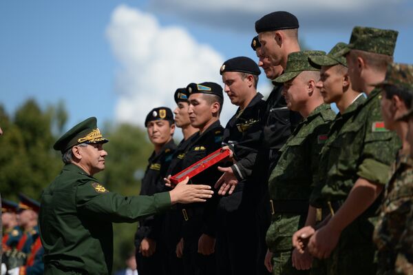 Министр обороны Российской Федерации Сергей Шойгу (слева) награждает победителей международных соревнований по танковому биатлону