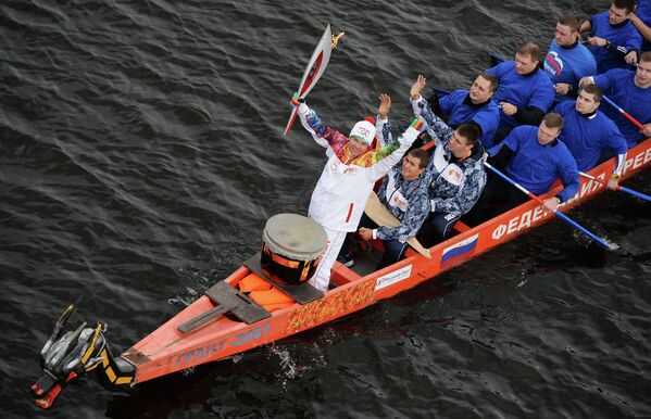 Участники эстафеты олимпийского огня на лодке в акватории Волги в Твери