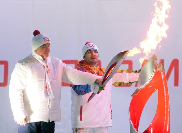 Губернатор Самарской области Николай Меркушкин (слева) и факелоносец Тагир Хайбулаев на торжественной церемонии зажжения чаши олимпийского огня в Самаре