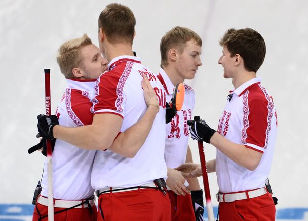 Спортсмены сборной России радуются победе в матче кругового турнира между сборными командами Германии и России в соревнованиях по керлингу