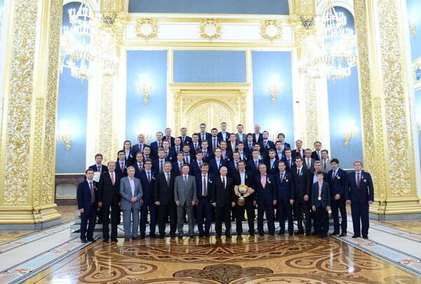 Президент России Владимир Путин (в центре) с хоккеистами и тренерами национальной сборной России по хоккею