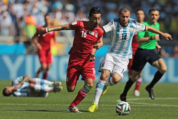 Нападающий сборной Ирана Реза Гооханнеяд (слева) и полузащитник Аргентины Хавьер Маскерано