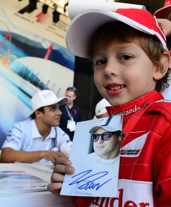 Юный болельщик Формулы-1 с автографом пилота команды Уильямс Фелипе Массы