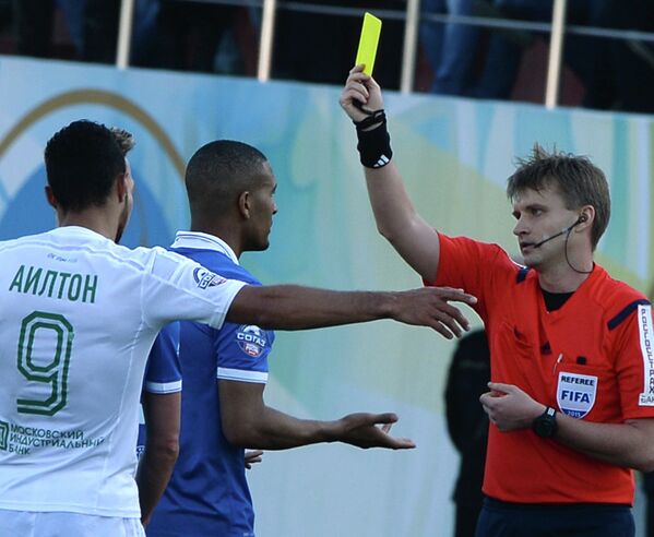 Главный судья Сергей Лапочкин показывает желтую карточку защитнику Динамо Вильяму Ванкёру (справа налево)