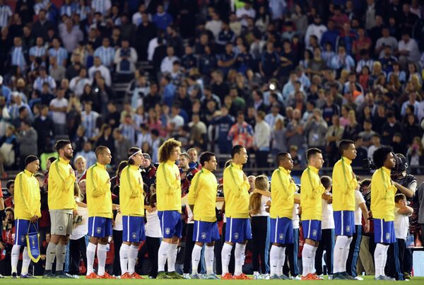 Футболисты сборной Бразилии и болельщики во время минуты молчания в память о жертвах серии терактов в Париже