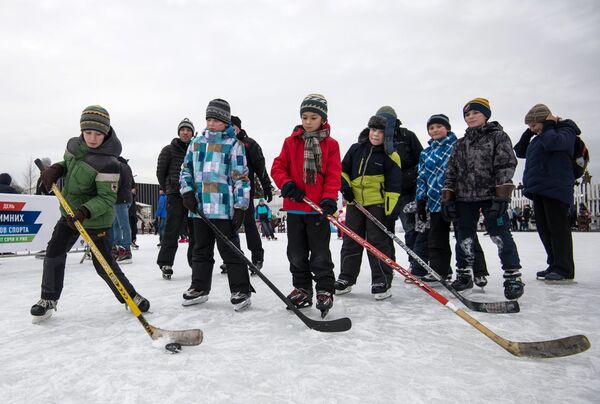 Дети на мастер-классе по хоккею на катке на ВДНХ во время празднования Дня зимних видов спорта в Москве